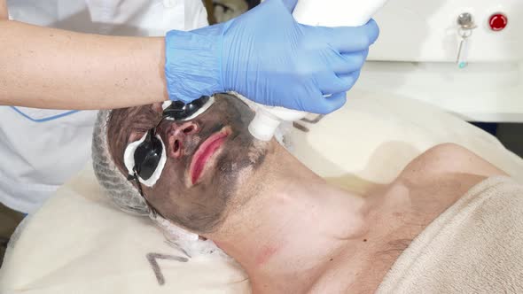 Cosmetologist Doing Facial Carbon Peeling for Male Client