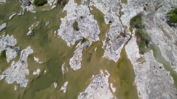 Aerial footage of the popular area on the Llano River in Texas called The Slab. Camera is recording