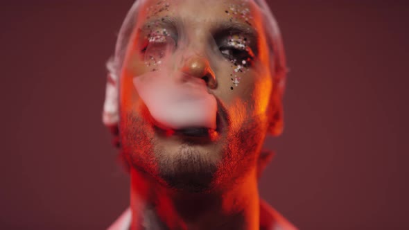 Loop Shot Of Man Blowing Smoke