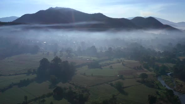 Aerial View of Pai Rice Fields During Sunrise with Fog in Mae Hong Son Thailand