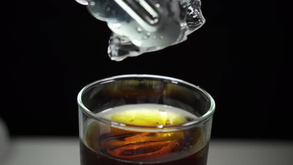 Dropping Ice Cube Into drink in a Glass stock video footage 