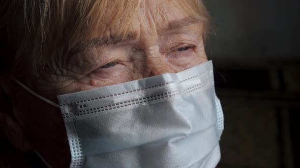 Portrait Of Elderly Woman In Protective Mask On Her Face From Coronavirus