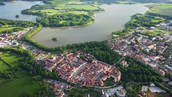 Aerial view of a large muddy pond near the historic town of Trebon surrounded by protected landscape