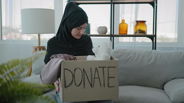 Arabian Kind Woman at Home Islamic Muslim Girl Volunteer in Black Hijab Sitting on Sofa with