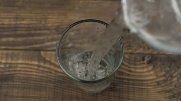 Close up pouring purified fresh drink water