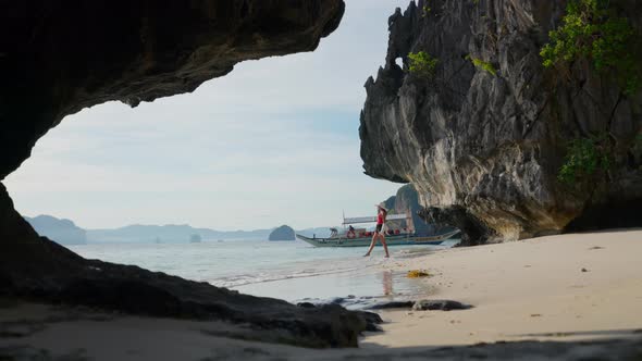 Woman Walking On Shore Of Entalula Beach