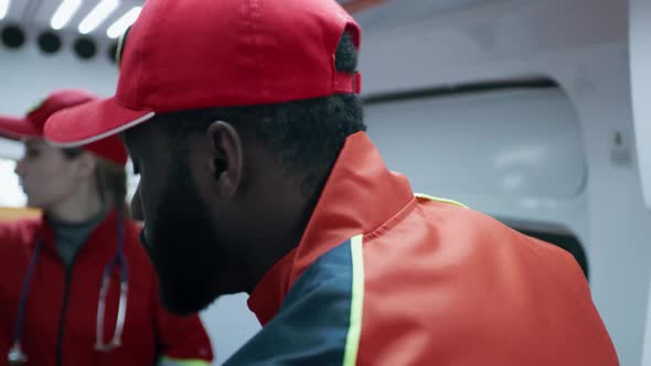 Black Paramedic Working in Ambulance