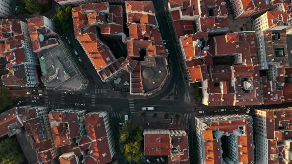 Top down drone shot over red rooftops European City at sunset golden hour Lyon France