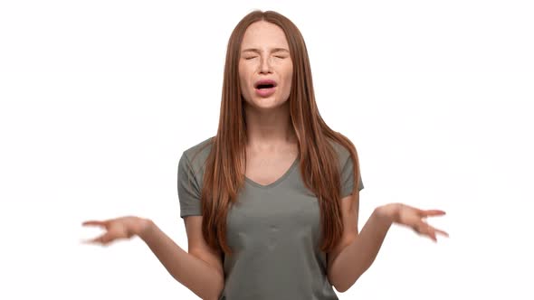 Portrait of Annoyed Woman 20s in Casual Tshirt Gesturing in Furious Manner and Asking What with