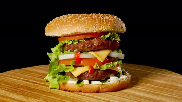 Cheeseburger with Bacon on a Dark Background. Close-up. Macro Shooting.