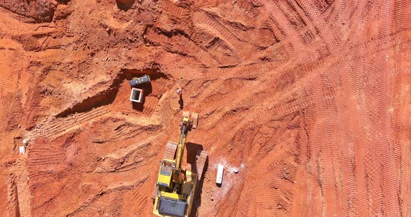 Digger on Earthworks in Excavator Dig the Trenche at Construction Site on Arial View