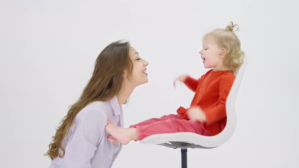 Playfully Baby Sits on Chair in Front of Doctor Shows Tongue Throat Health Care