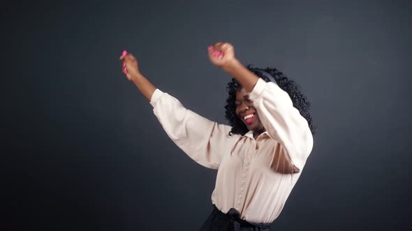 AfricanAmerican Lady with Headphones Dances on Black