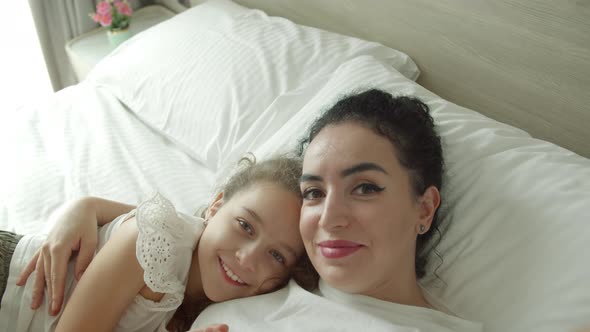 Portrait Happy Cute Funny Cheerful Mom and Daughter Gently Hugging Daughter with Mom Take Selfie