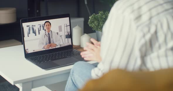 Asia using computer laptop talk about disease in video conference call with senior doctor online.