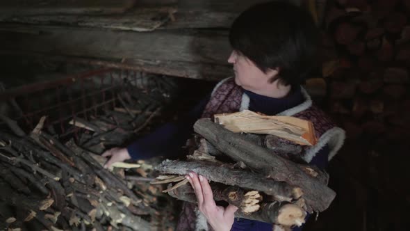 An Elderly Woman with Handful of Firewood