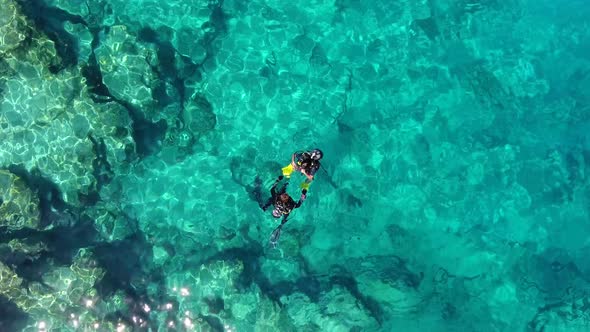 Aerial View of Divers Swimming Underwater Sea