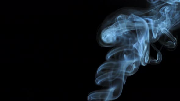 Abstract Smoke Rises Up in Beautiful Swirls on a Black Background