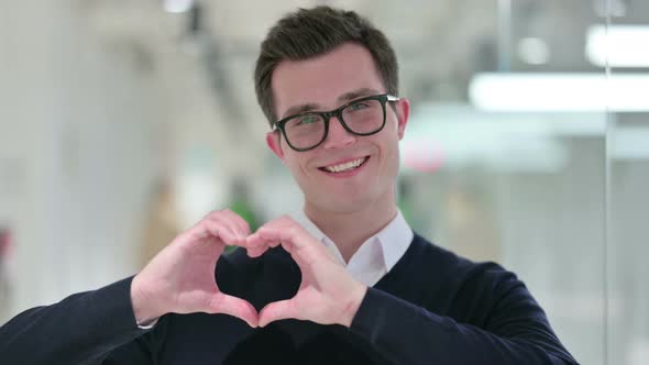 Young Businessman Showing Heart Sign with Hand