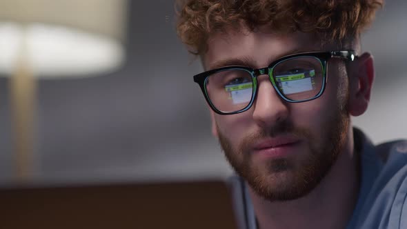 Portrait of Man Working at Night Looking at Monitor Reflections in Eyeglasses