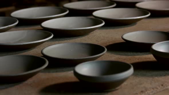 Handmade Ceramic Plates on Table at Workshop.