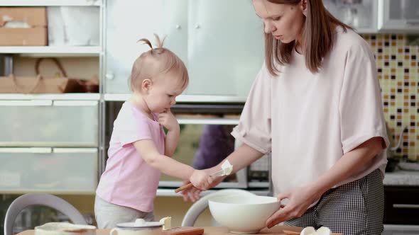 Little Cute Funny Girl Helping Mother Prepare Pie Cake in Kitchen Baking Homemade Cookie Together