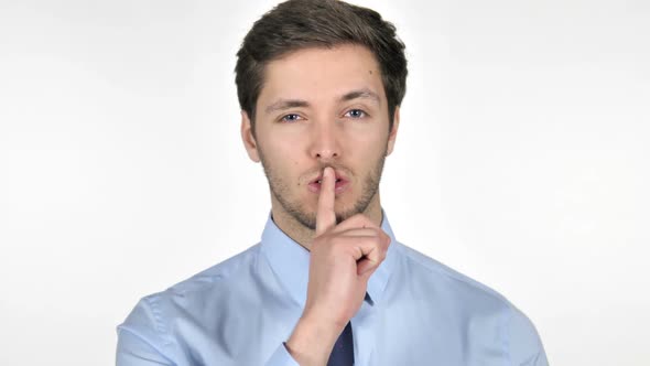 Finger on Lips By Young Businessman Isolated on White Background