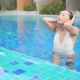 Young asian woman enjoy around outdoor swimming pool for leisure - VideoHive Item for Sale