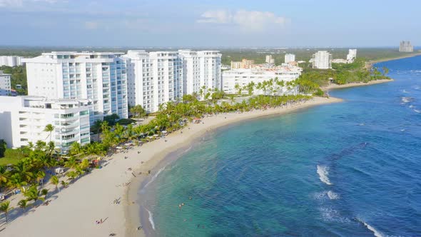 Luxury Beachfront Accommodation Buildings Along Playa Juan Dolio In Dominican Republic. aerial drone