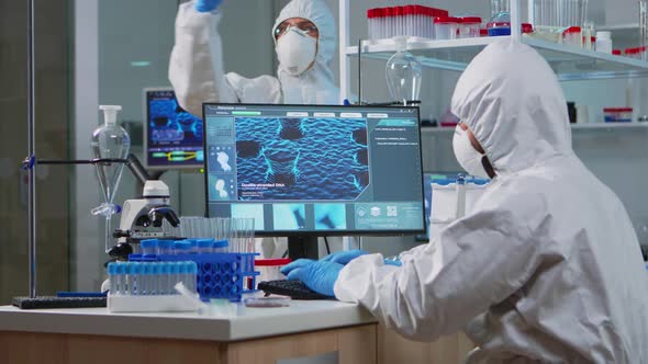 Medical Scientist in Ppe Suit Working with DNA Scan Image