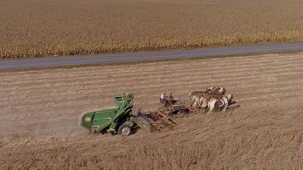 Drone Flight over Agricultural Fields and Wheat Fields being Harvested by Amish Farmer and Horses