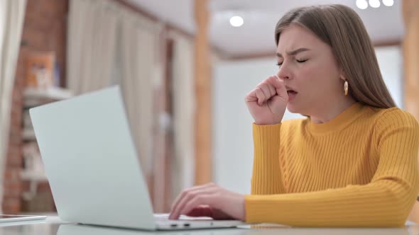 Sick Young Creative Young Woman Coughing in Office