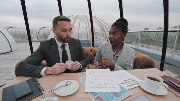 Business Woman and Man in Rooftop Cafe