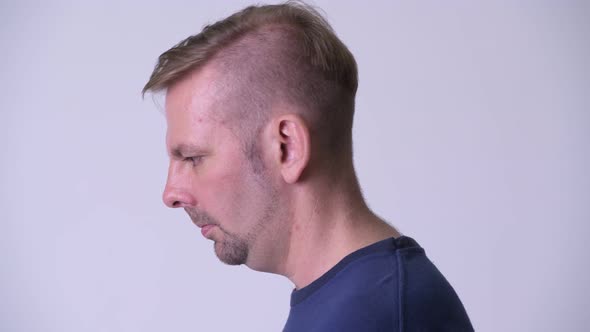 Head Shot Profile View of Blonde Man Looking Up