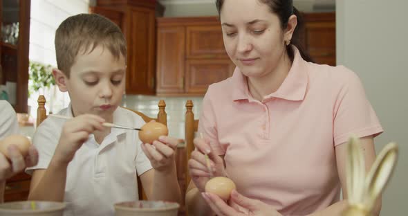 Mother and Son Paint an Egg