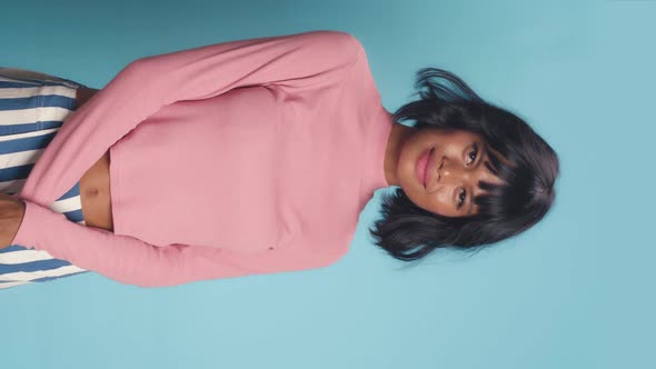 Young Pretty African American Woman Looks at Camera with Arms Crossed