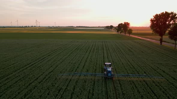 Tractor Spray Fertilizer on Agricultural Field Aerial View