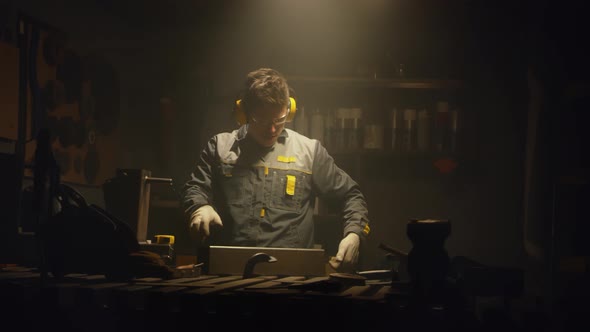 A metal worker works in a workshop