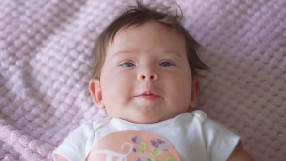 Slow Motion of Beautiful Baby with Blue Eyes Looking at Camera