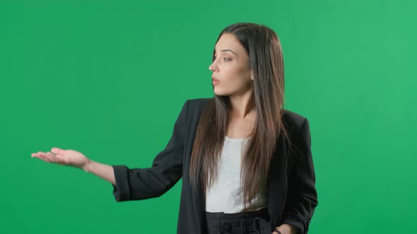 Young Business Woman Presenting Product on Green Background. Portrait of Female Professional