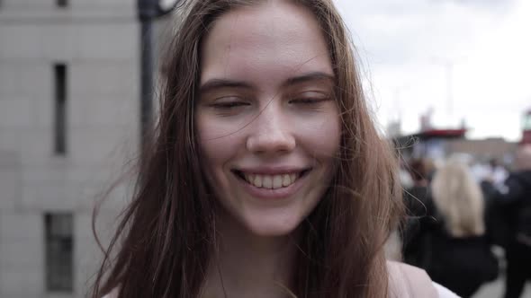 Young beautiful woman portrait on the sidewalk