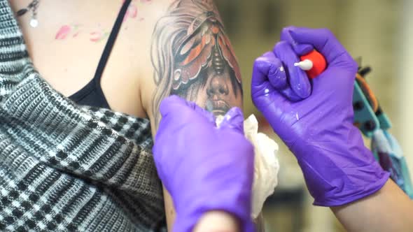 Tattoo artist tattooing an arm