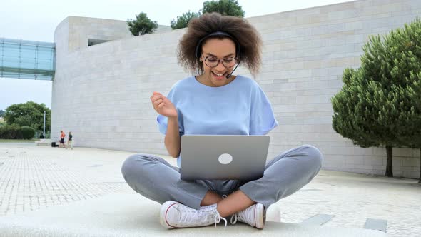 Clever Happy African American Young Woman with Headset Company Employee Conducts Distant Online