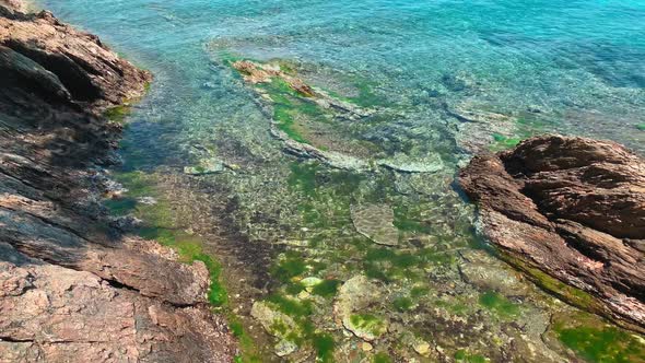 A Picturesque Sea Landscape of a Blue Lagoon with a Sharp Rocks at Sunrise Rocky Coast Mountains on