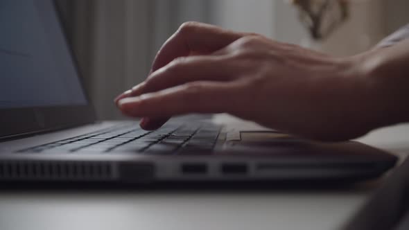 Female Hands Typing on Laptop Keyboard Indoors