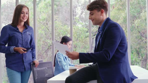 Happy Businesswoman and Businessman Having Conversation in Modern Office