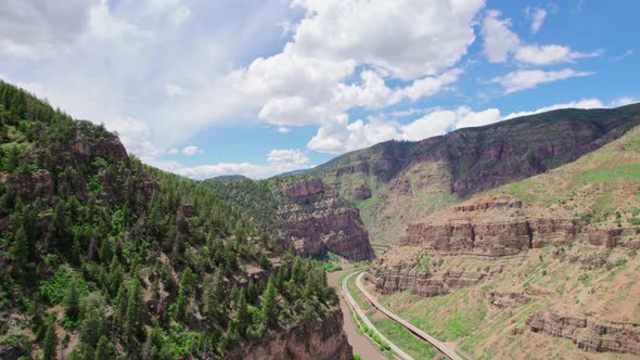 Wide Open Deep Canyon Gorge Covered In Healthy Green Pine Tree Foliage During Bright Hot Summer Day