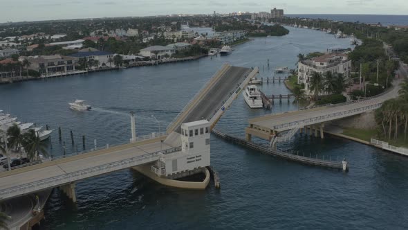 Aerial orbital shoting around bridge while its rising to allow oncoming traffic