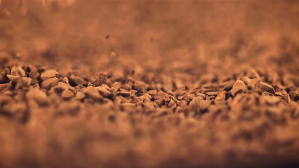 Super Slow Motion Pellets of Instant Coffee Fall Into a Heap