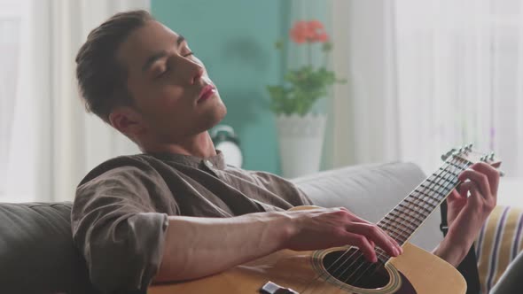 Young Man Is Meditating By Playing Guitar